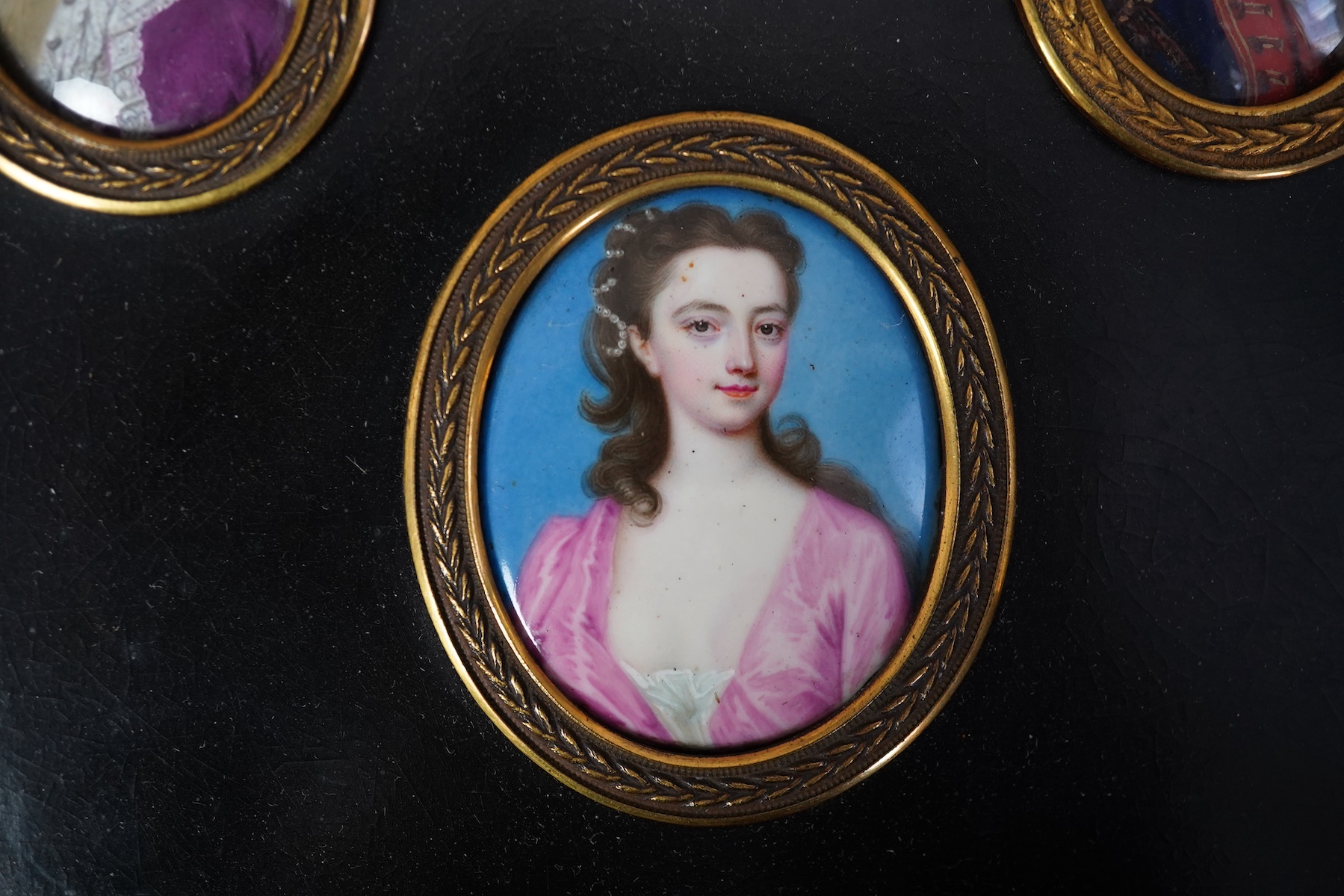 English School c.1760, Miniature portraits of the Cartwright Family, enamel on copper (4), largest 4.5 x 3.75cm, framed as one